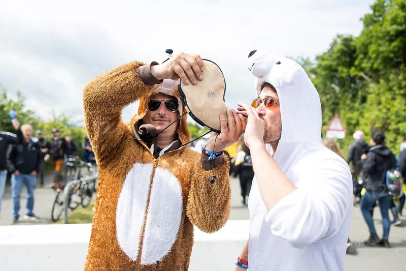 Two festival visitors in animal costumes drink from a horn at the Rock am Ring festival on Friday, Nürburgring race track race track, 06/06/2025