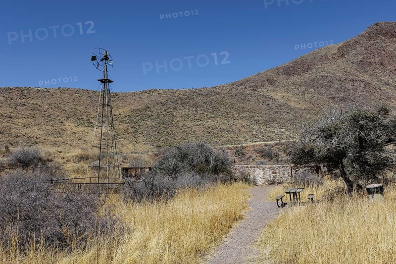 Picnic table and old abandoned windmill along the Bar Canyon Trail in Organ Mountains - Desert Peaks National Monument in New Mexico, USA
