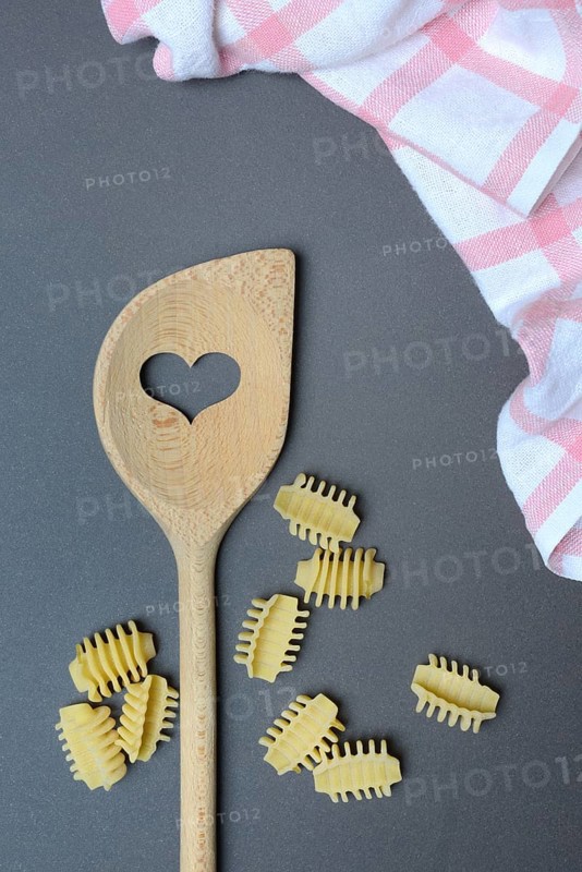 Cooking spoon with heart and Italian pasta, Radiatori variety