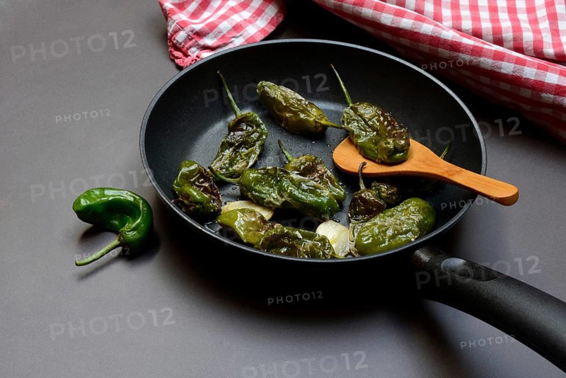Pan-fried pimientos de padron in olive oil, roast peppers