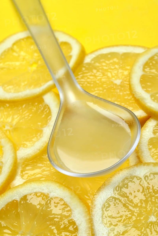 Lemon juice in ladle and lemon slices, Citrus x limon