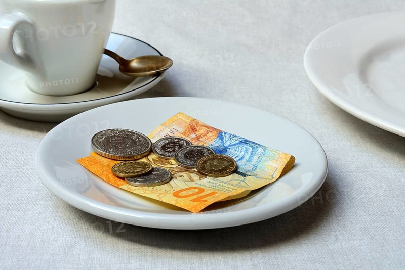 Tip, Swiss coins and Swiss franc note on plate, Switzerland