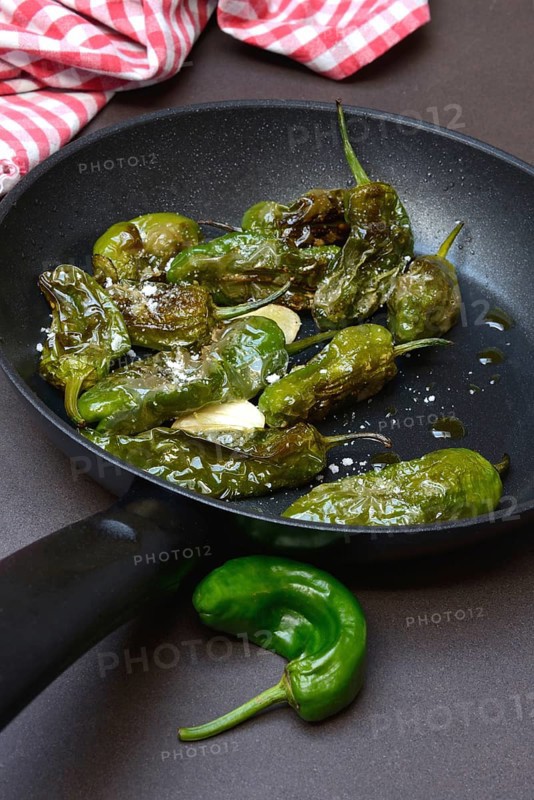 Pan-fried pimientos de padron in olive oil, roast peppers