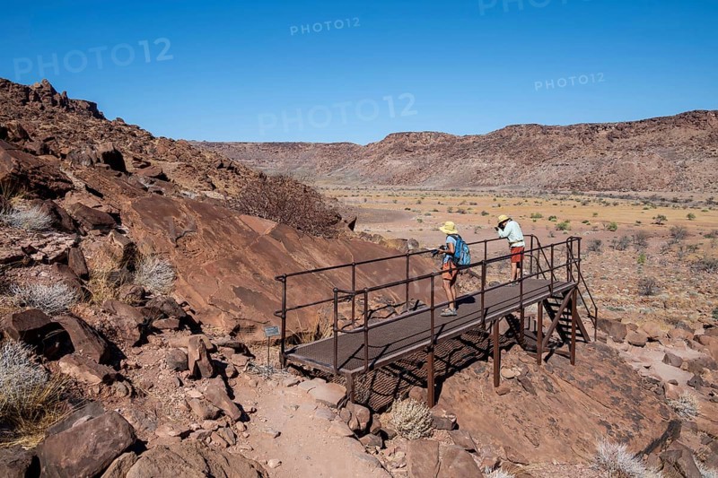 Tourists on a platform at the rock engravings of Twyfelfontein, Twyfelfontein, Kunene, Namibia