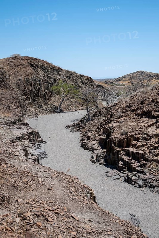 Dry river valley with basalt rocks, rock formation Organ Pipes, Damaraland, Kunene, Namibia