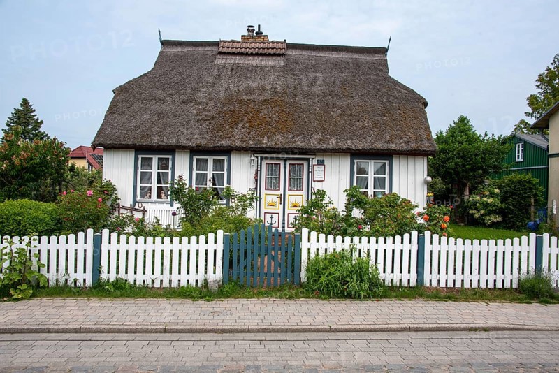 White thatched house with lovingly designed front garden. Wieck, Mecklenburg-Western Pomerania, Germany