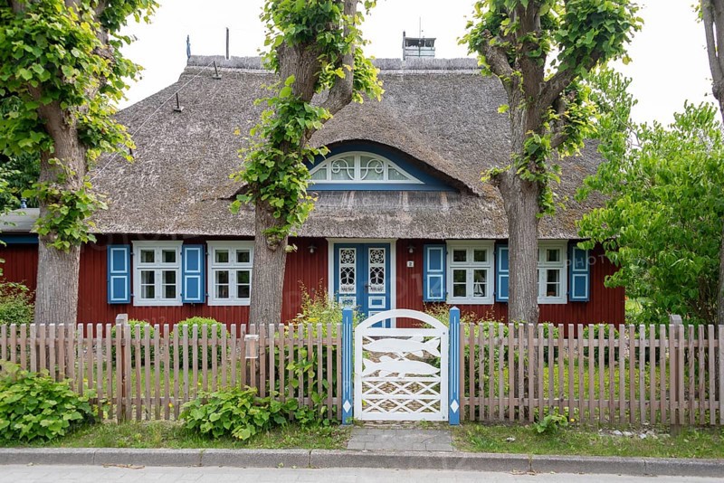 Picturesque thatched house with blue shutters, Wieck, Mecklenburg-Vorpommern, Germany