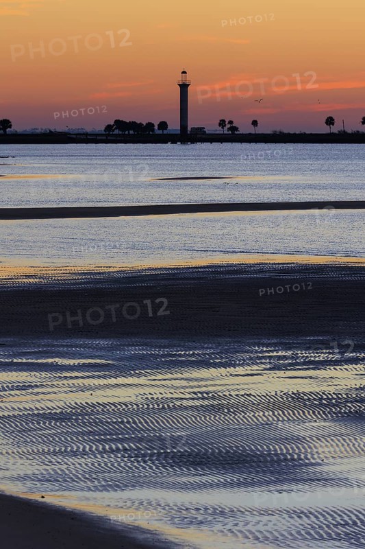 Sunrise silhouette of Broadwater Beach Marina Light at Biloxi, Mississippi, USA