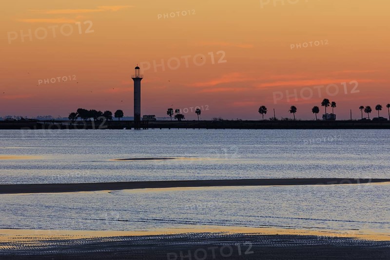 Sunrise silhouette of Broadwater Beach Marina Light at Biloxi, Mississippi, USA
