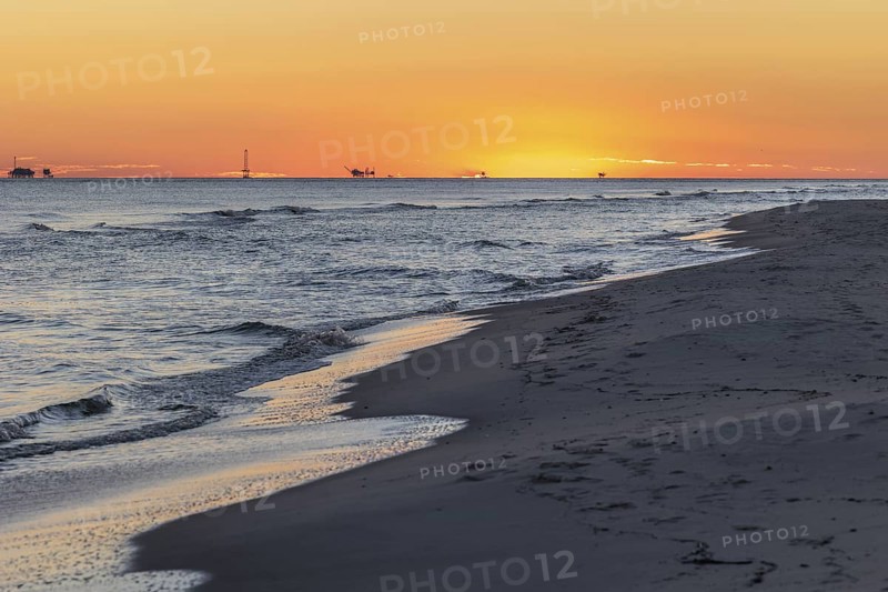 Oil and gas drilling rigs on the Gulf of Mexico horizon at Fort Morgan, Alabama, USA