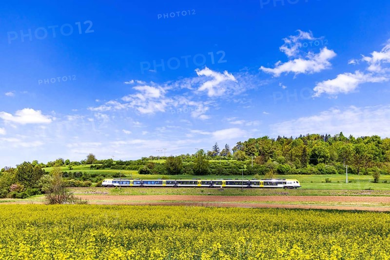 Regional train travelling on the Swabian Alb. Landscape on the railway line in spring. Lonsee, Baden-Württemberg, Germany