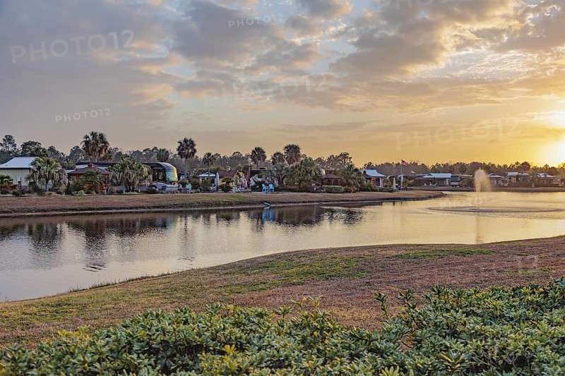 Motorhomes with waterfront lots in RV Resort at sunset in southern Alabama, USA