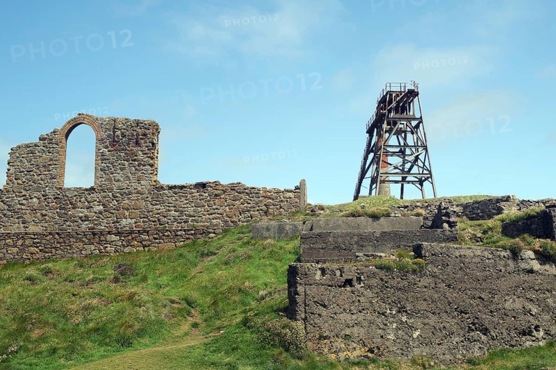 Mining ruins and a derelict tower stand on a grassy hill, engine room, mining, Botallack, Cornwall, England, Great Britain