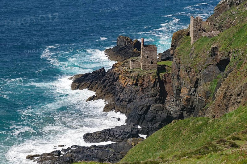 Historic ruins on a rocky cliff above the roaring sea and deep blue sky, engine room, mining, Botallack, Cornwall, England, Great Britain