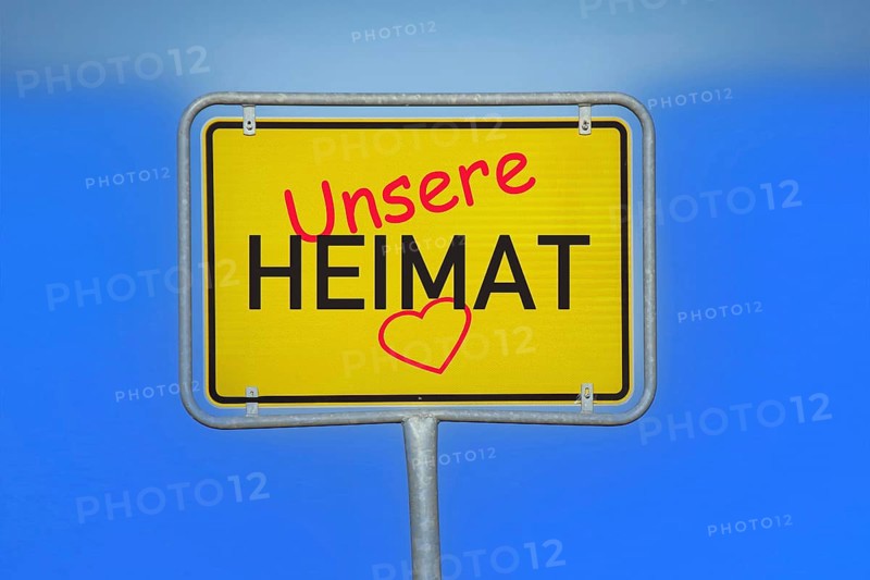 (Photomontage) Town sign with the inscription UNSERE HEIMAT and a heart