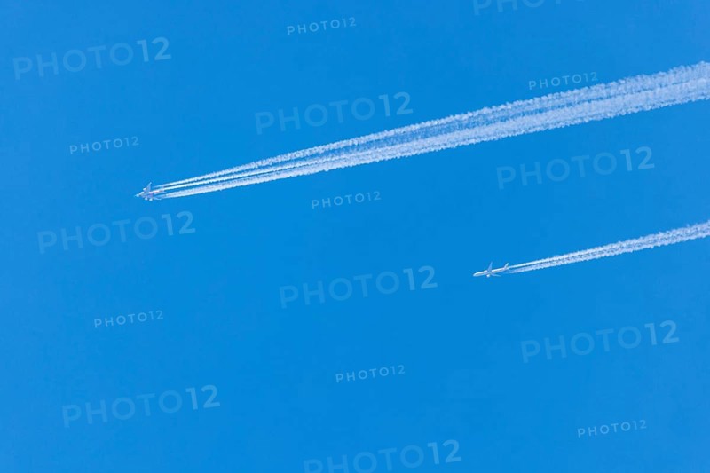 Two aeroplanes with vapour trails in the bright blue sky, Ternitz, Lower Austria, Austria