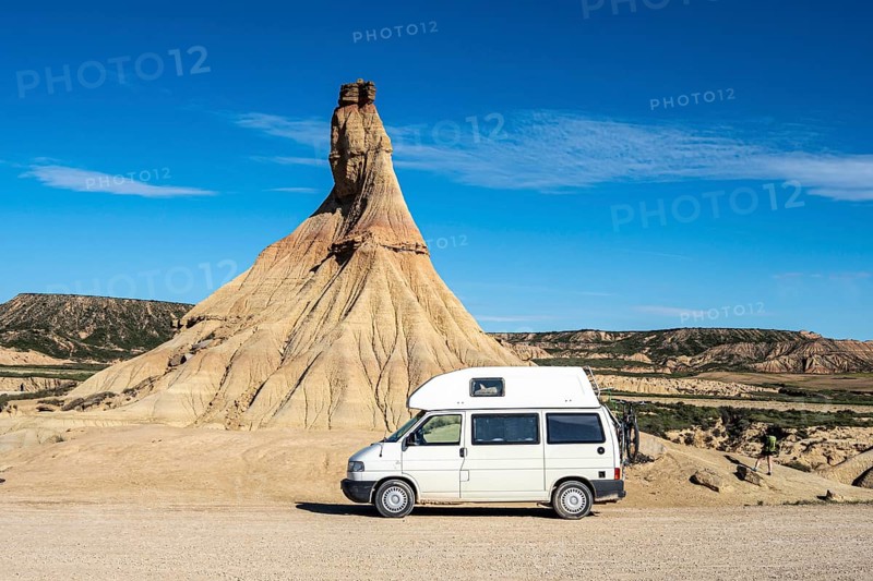 Camper van in front of Castildetierra rock formation, semi-desert, Bardena Blanca area, Bardenas Reales Nature Park, Navarre, Spain