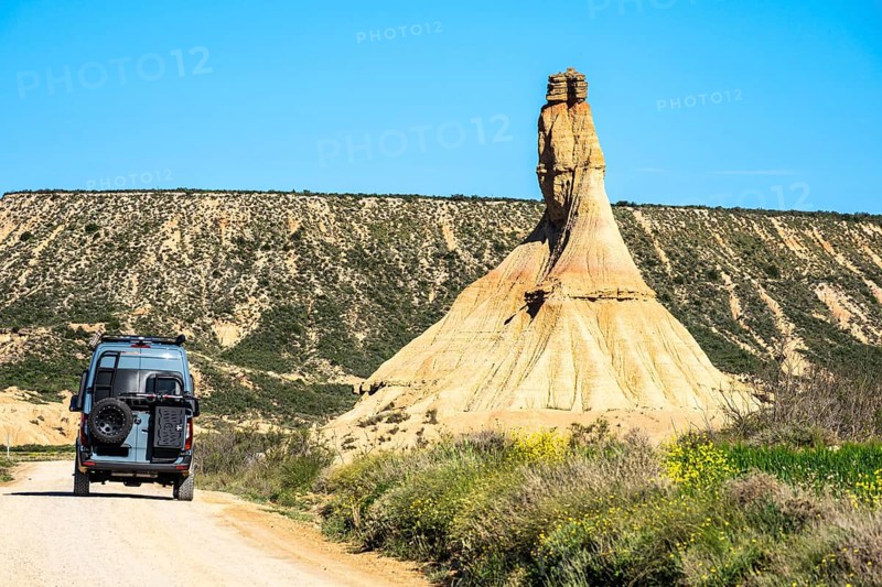 Camper van at Castildetierra rock formation, semi-desert, Bardena Blanca area, Bardenas Reales Nature Park, Navarre, Spain