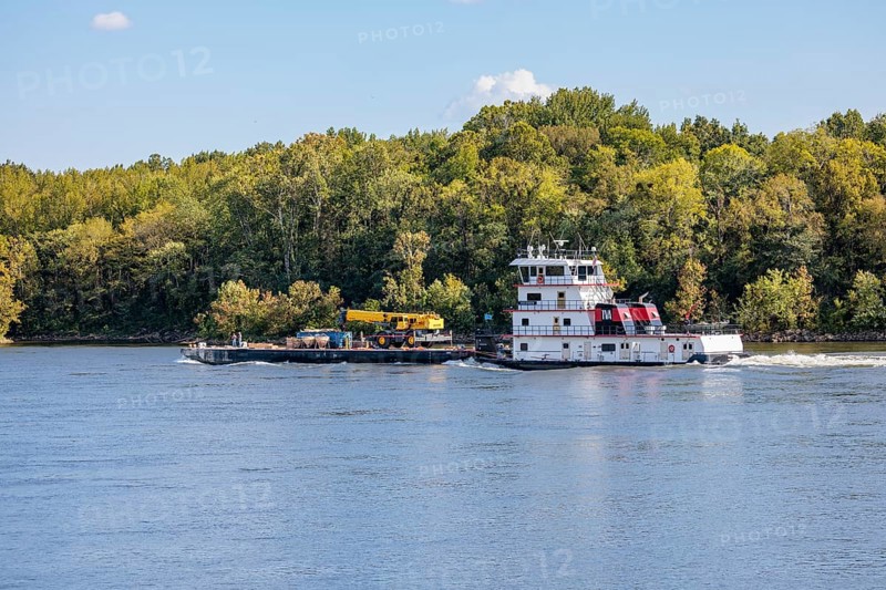 Tennessee Valley Authority tug boat Freedom pushing a barge with construction equipment upstream on the Tennessee River near Counce, Tennessee