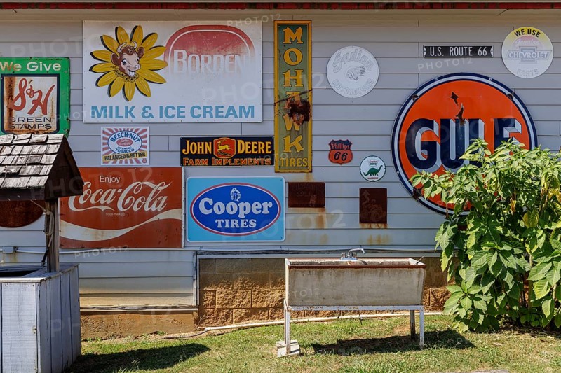 Antique metal advertising signs used for decoration on the side of a building near Counce, Tennessee