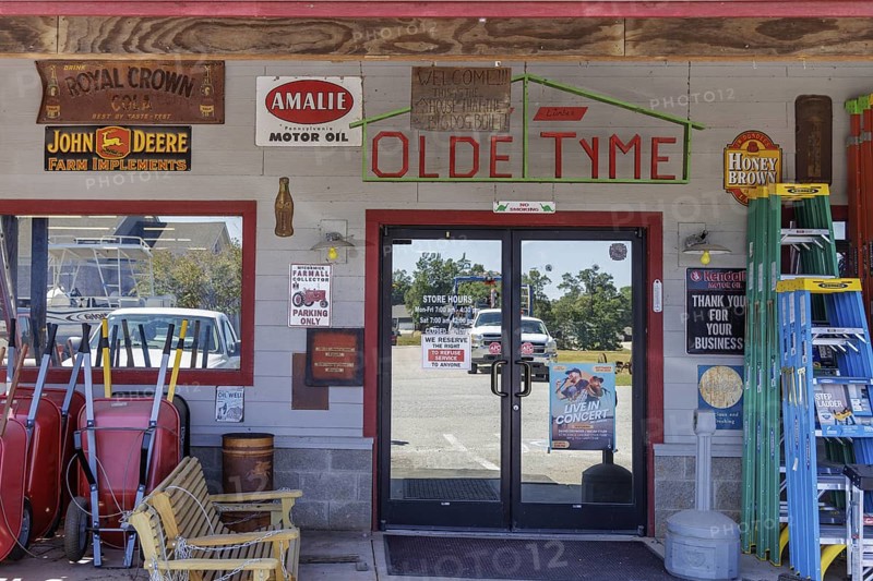 Antique metal advertising signs used for decoration on the side of the Olde Tyme Hardware and Lumber store building near Counce, Tennessee