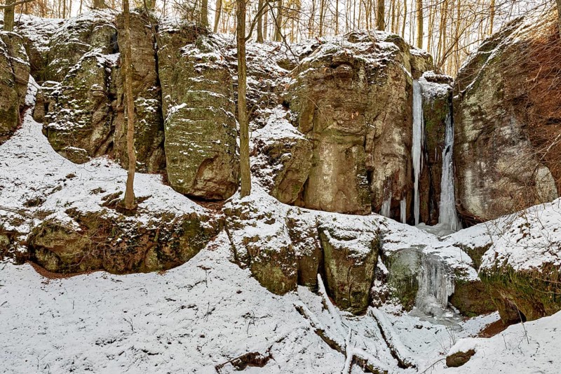 Snow-covered rocks with frozen waterfalls in a forest, The Dragon Gorge near Eisenach in Thuringia
