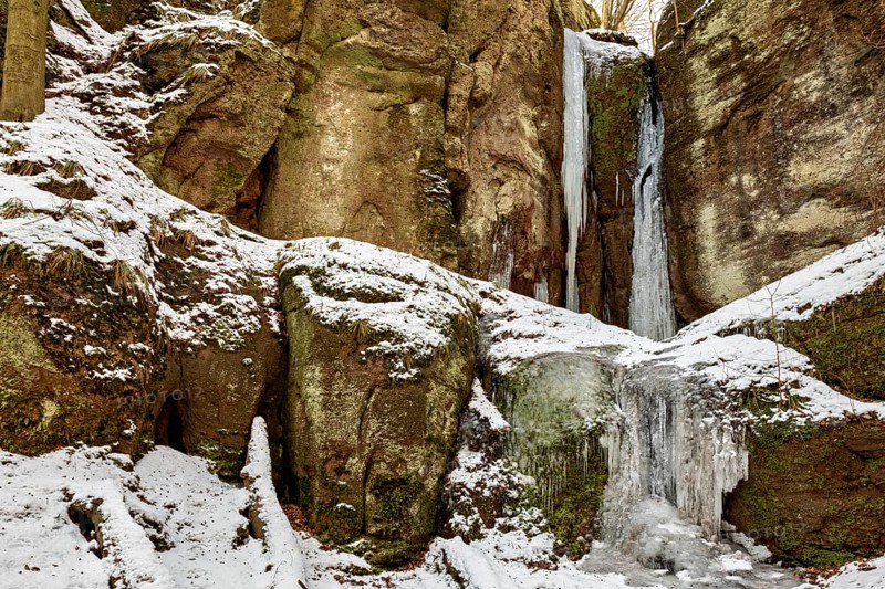 Frozen waterfalls on snow-covered rocks in a winter landscape, The Dragon Gorge near Eisenach in Thuringia