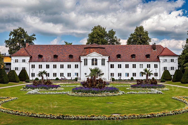 White castle with elaborately designed garden and colourful flower beds, The town of Kempten im Allgäu