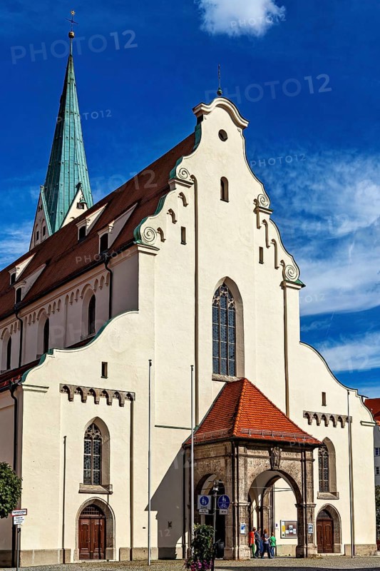 Gothic church with a high tower and red roofs under a blue sky, The town of Kempten in the Allgäu