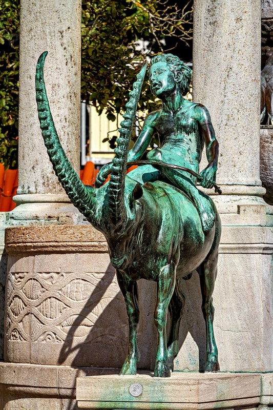 Bronze figure of a rider on a mystical animal, skilfully designed with long horns, The fountain in the town of Kempten im Allgäu