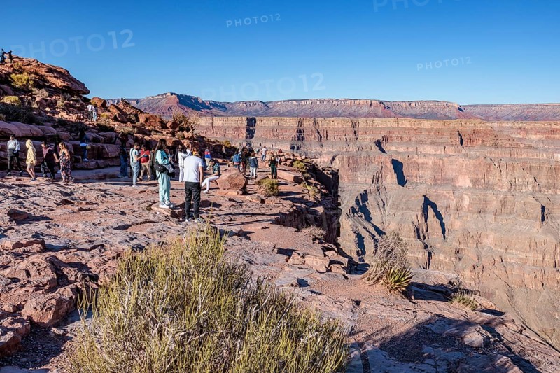 Tourists on the edge of the canyon at Guano Point area of Grand Canyon West near Peach Springs, Arizona