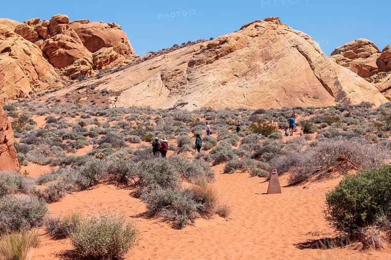 Hikers near the trailhead of the Fire Canyon Overlook Trail at Valley of Fire State Park near Overton, Nevada
