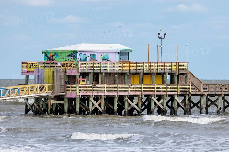 Pelicans and the Shark bar at the 61st Street Fishing Pier on the Texas Gulf Coast at Galveston, Texas