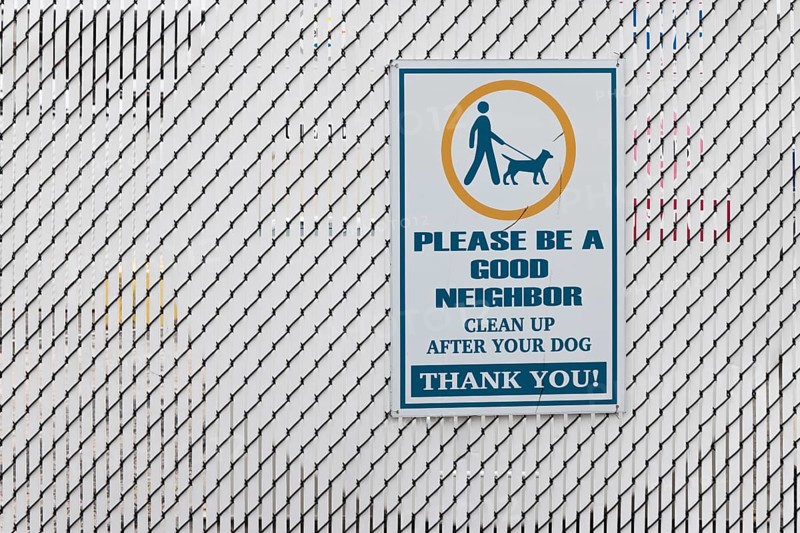 Sign reminds dog owner to clean up after their dog