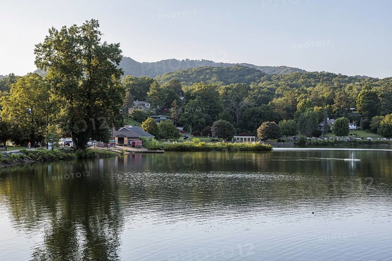 Youth paddles his paddleboard away from Lake Junaluska Outfitters launch in Lake Junaluska, North Carolina