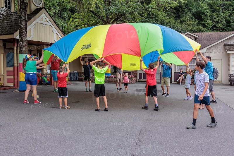 Children play with a parachute at the Dollywood amusement park in Pigeon Forge, TN
