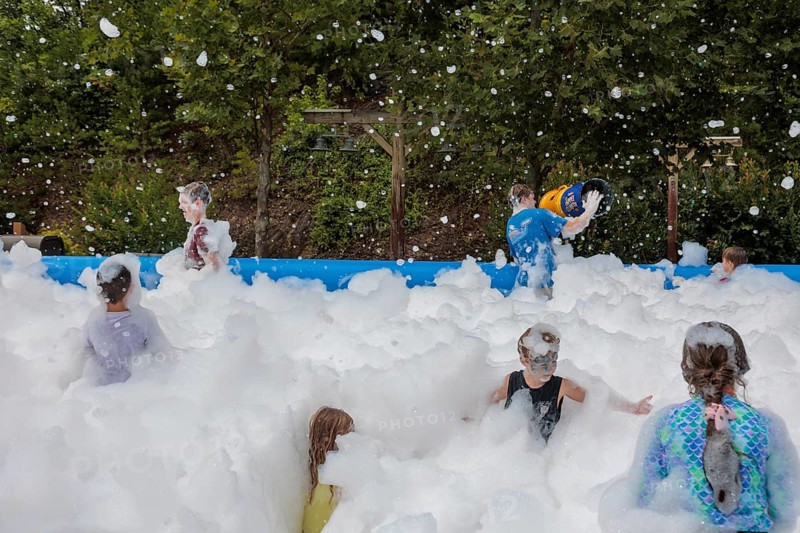 Park guests playing in the bubble foam pit at the Dollywood amusement park in Pigeon Forge, TN