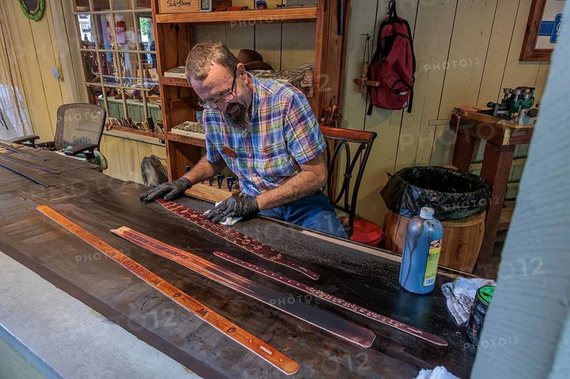 Craftsman demonstrated the art of belt making in Smoky Creek Leather and Hat Company at the Dollywood amusement park in Pigeon Forge, TN