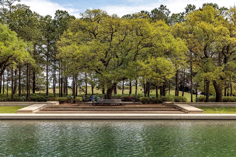 Live Oak trees line the sides of the Mary Gibbs and Jesse H. Jones Reflection Pool at Hermann Park in downtown Houston, Texas