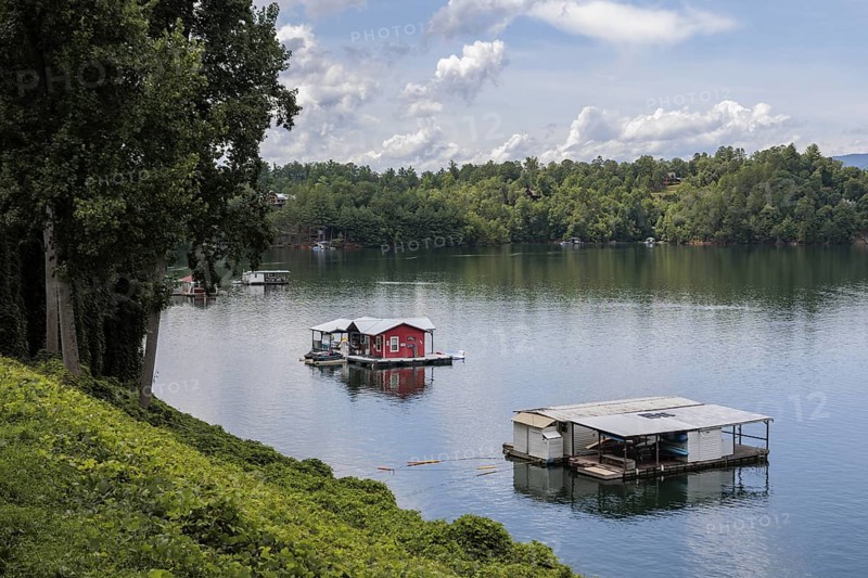 View of a house boats on Fontana Lake as seen from the open air car of the Great Smoky Mountains Railroad on its excursion from Bryson City, North Carolina