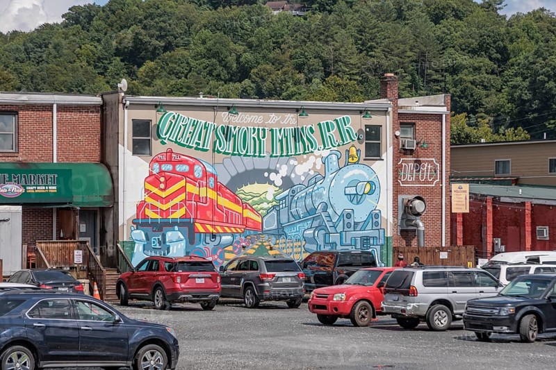 Mural on the back of a building welcomes Great Smoky Mountains Railroad passengers back to Bryson City, North Carolina