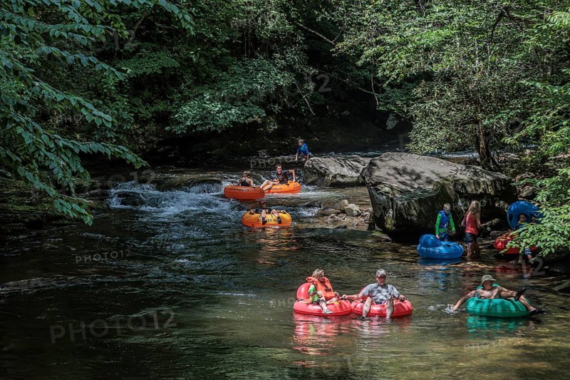 Visitors tubing down Deep Creek in the Smoky Mountains near Bryson City, North Carolina, USA