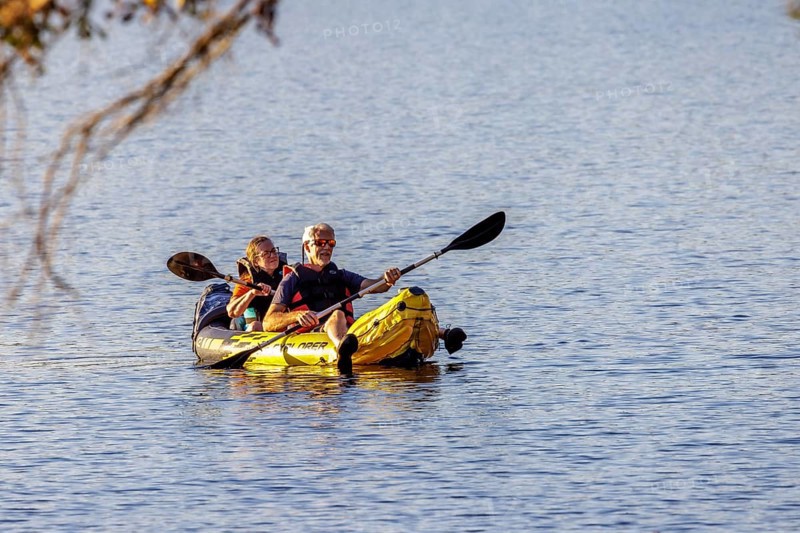 Senior couple paddleing a an inflatable kayak on Archusa Creek Lake at Archusa Creek Water Park near Quitman, Mississippi