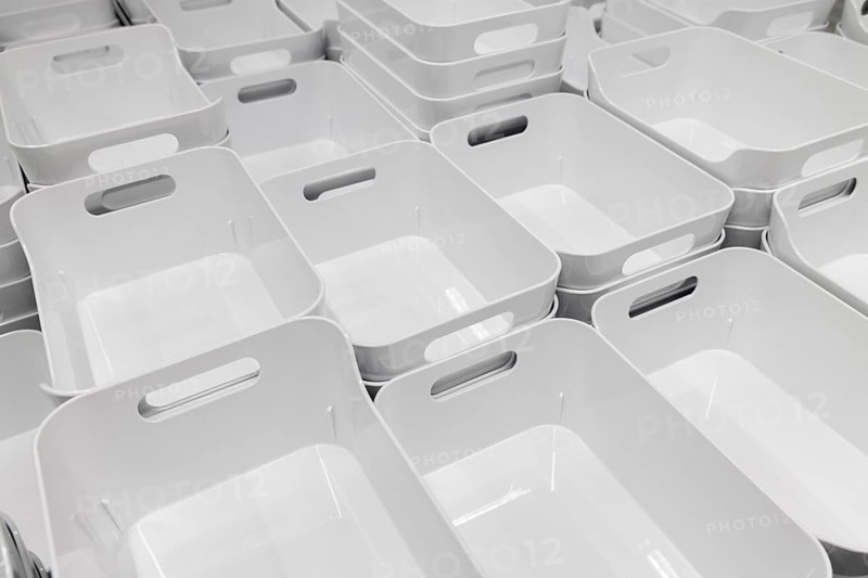 White plastic baskets neatly stacked in rows in the showroom section of the IKEA home store