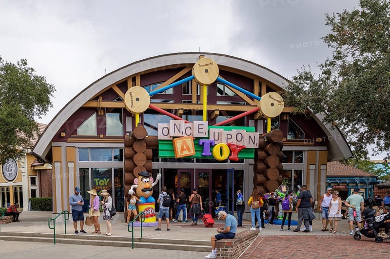 Shoppers and visitors walking past the Once Upon A Toy toy store in Disney Springs at Disney World in Orlando, Florida, USA