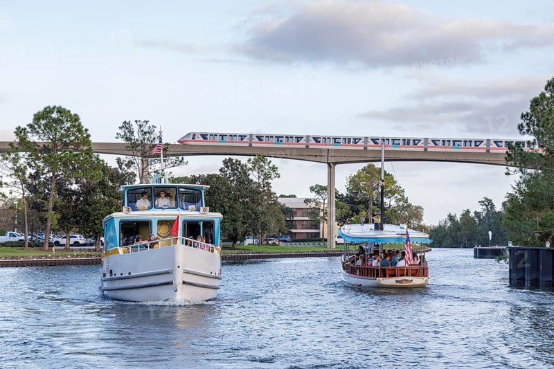 Monorail passing over water taxis in the channel between Bay Lake and Seven Seas Lagoon at Walt Disney World in Orlando, Florida, USA