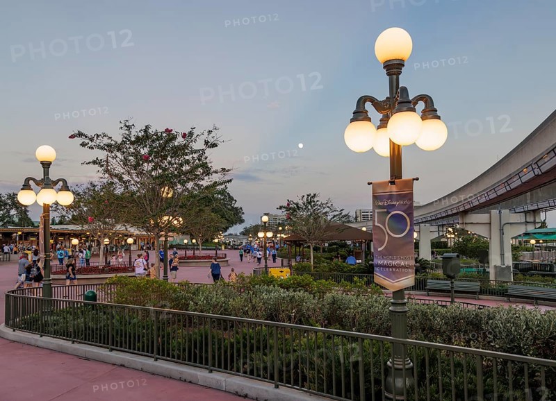 Moon in the sky in the early evening outside the entrance to the Magic Kingdom at Walt Disney World in Orlando, Florida, USA