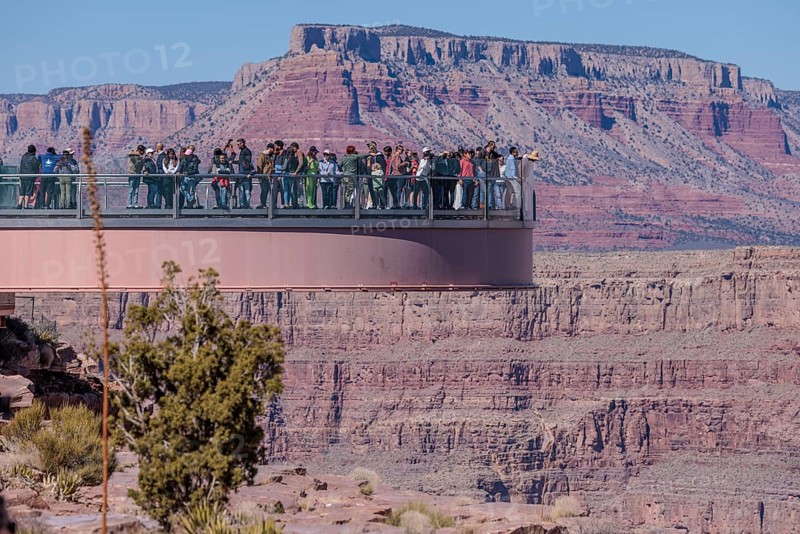 Visitors view the Grand Canyon from the Skybridge, a glass floored bridge extending 70 feet over the canyon at Eagle Point in Grand Canyon West near Peach Springs, Arizona