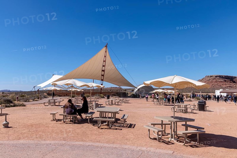 Umbrella shaded tables and a large awning provide visitors shade from the desert sun at Eagle Point in Grand Canyon West near Peach Springs, Arizona