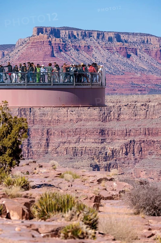 Visitors view the Grand Canyon from the Skybridge, a glass floored bridge extending 70 feet over the canyon at Eagle Point in Grand Canyon West near Peach Springs, Arizona